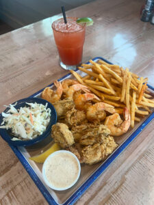 Fried shrimp and oysters combo with fries and coleslaw at Grumble's Seafood Co.