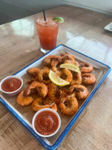 Tray of peel-and-eat shrimp with a cocktail at Grumble's Seafood Co.